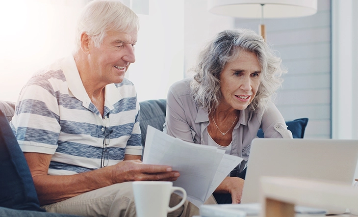 Senior couple reviewing retirement planning steps with a checklist